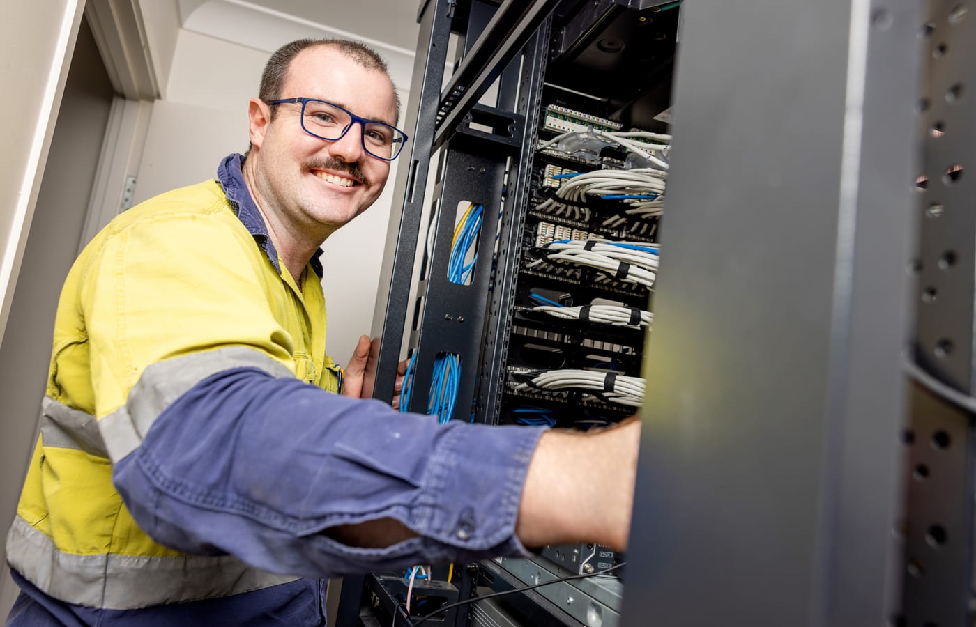 Give Industries team members smiling in high visibility workwear