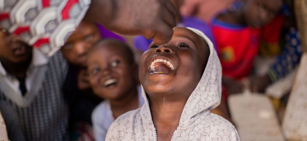 Child receiving vitamin A supplementation through a Helen Keller International health program