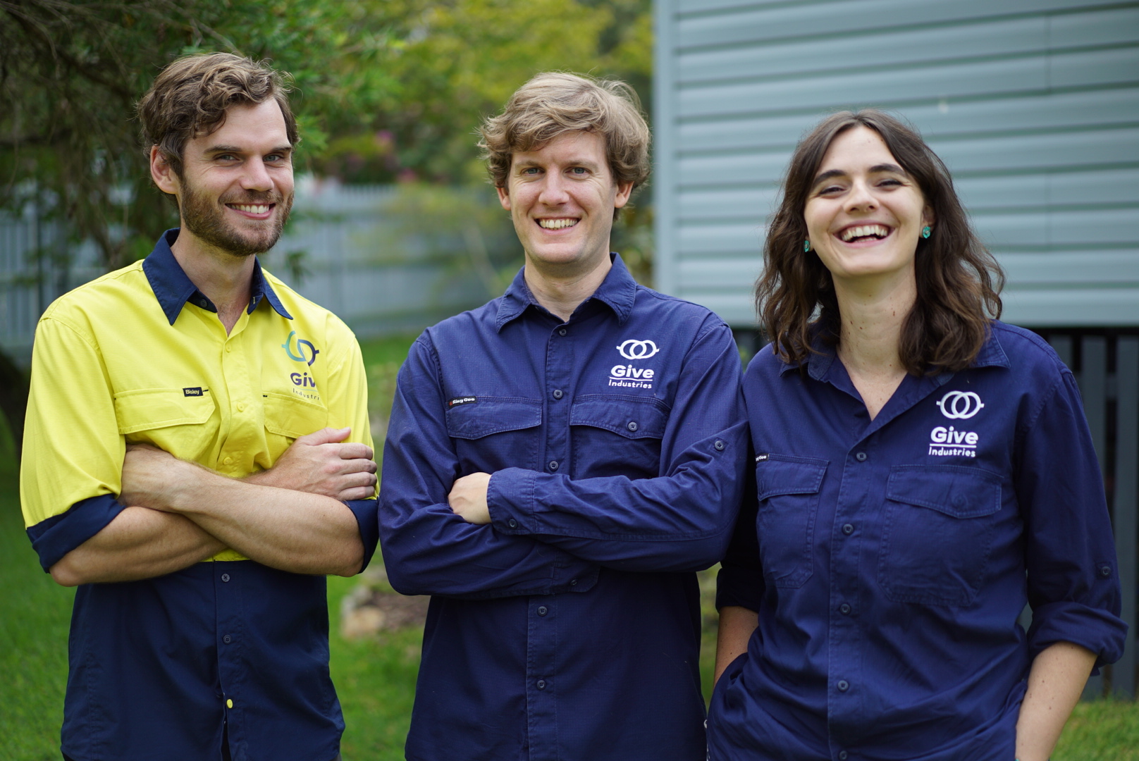 Give Industries founders standing together in Give Industries uniforms